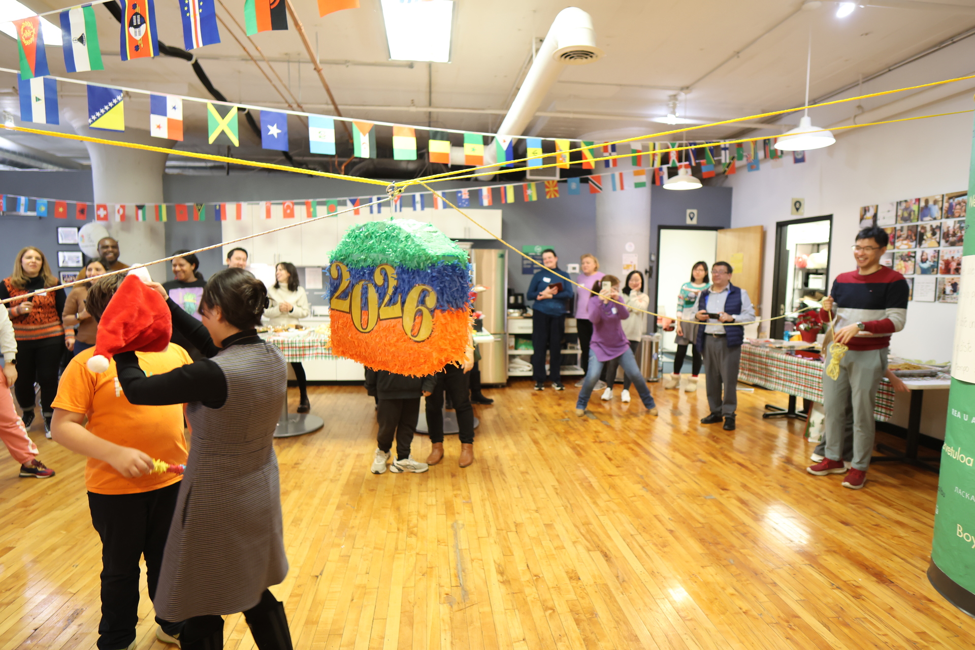 Community members in front of a colorful mural